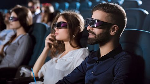 Young happy couple having a date at the cinema