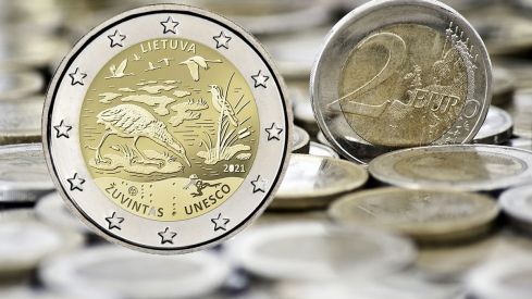 Grungy 2 euro coin with coins on background