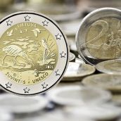 Grungy 2 euro coin with coins on background