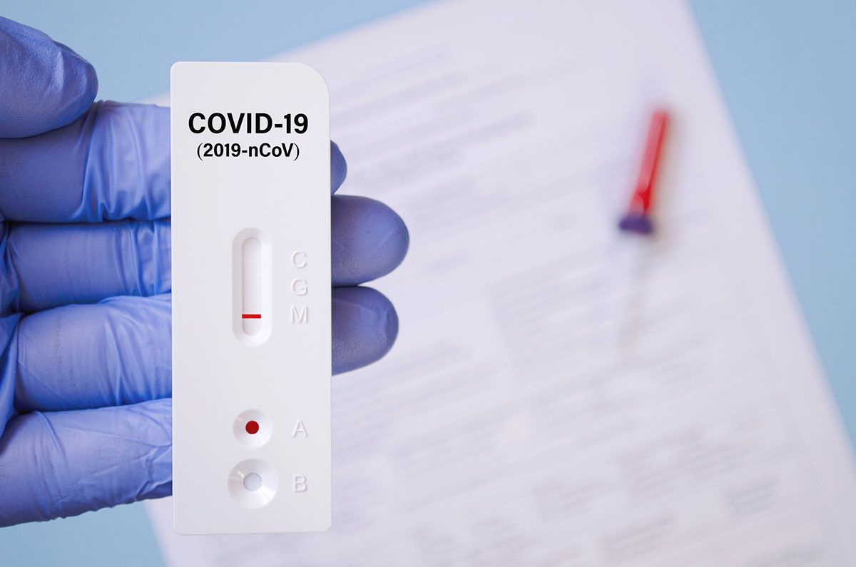 Positive test result by using rapid test for COVID-19, quick fast antibody point of care testing. Lab performing rapid diagnostic test for antibodies to detect presence of antigens COVID-19 disease.