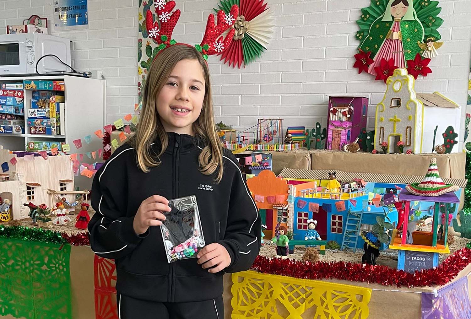 Adriana con una de sus pulseras hechas a mano frente al belén de la Sala de Juegos de Pediatría de la Gasbi Adriana con una de sus pulseras hechas a mano frente al belén de la Sala de Juegos de Pediatría de la Gasbi